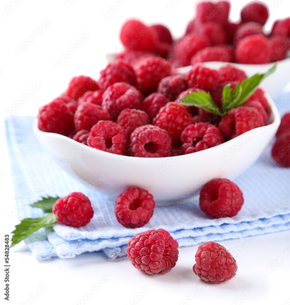Ripe sweet raspberries in bowls, isolated on white Ripe sweet raspberries in bowls, isolated on white