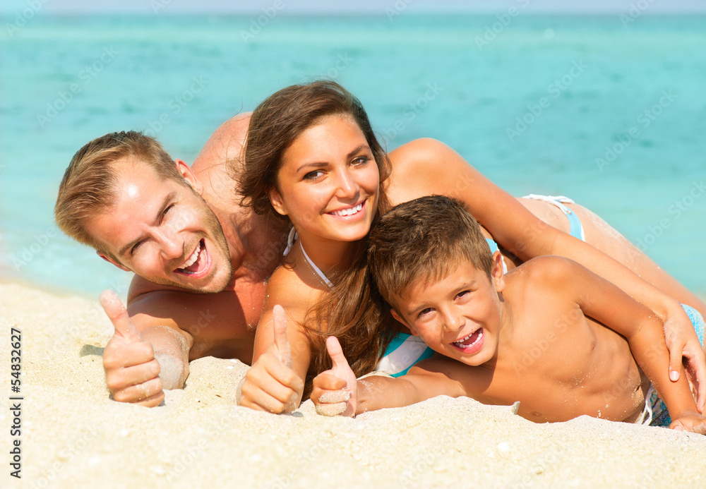 Happy Young Family with Little Kid Having Fun at the Beach Happy Young Family with Little Kid Having Fun at the Beach