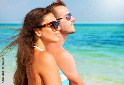 Happy Couple in Sunglasses on the Beach. Summer Vacation © Subbotina Anna