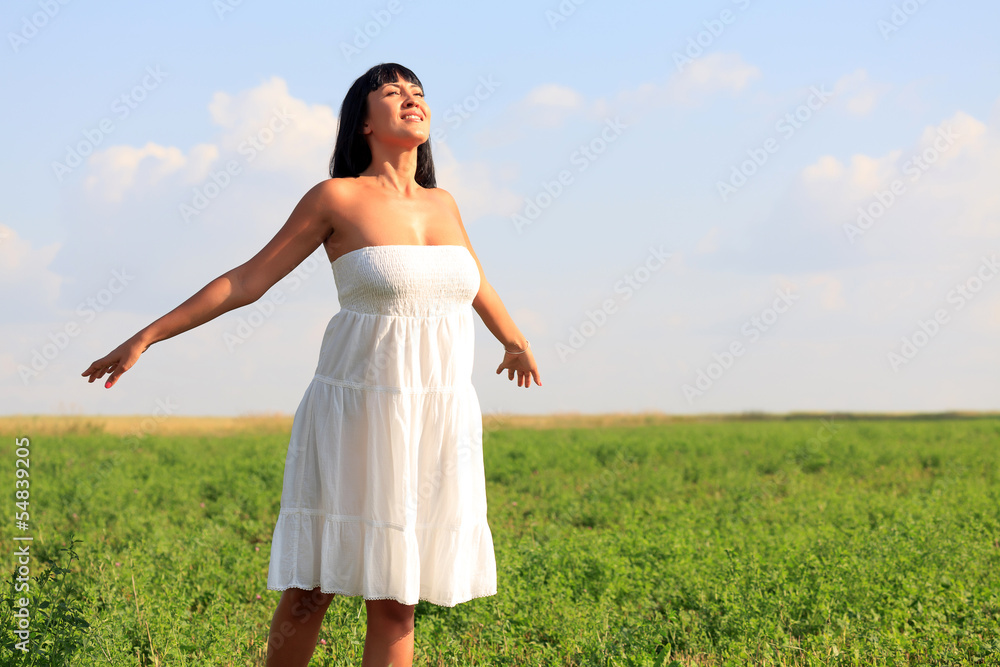 Young happy woman breathing fresh air in green field Young happy woman breathing fresh air in green field