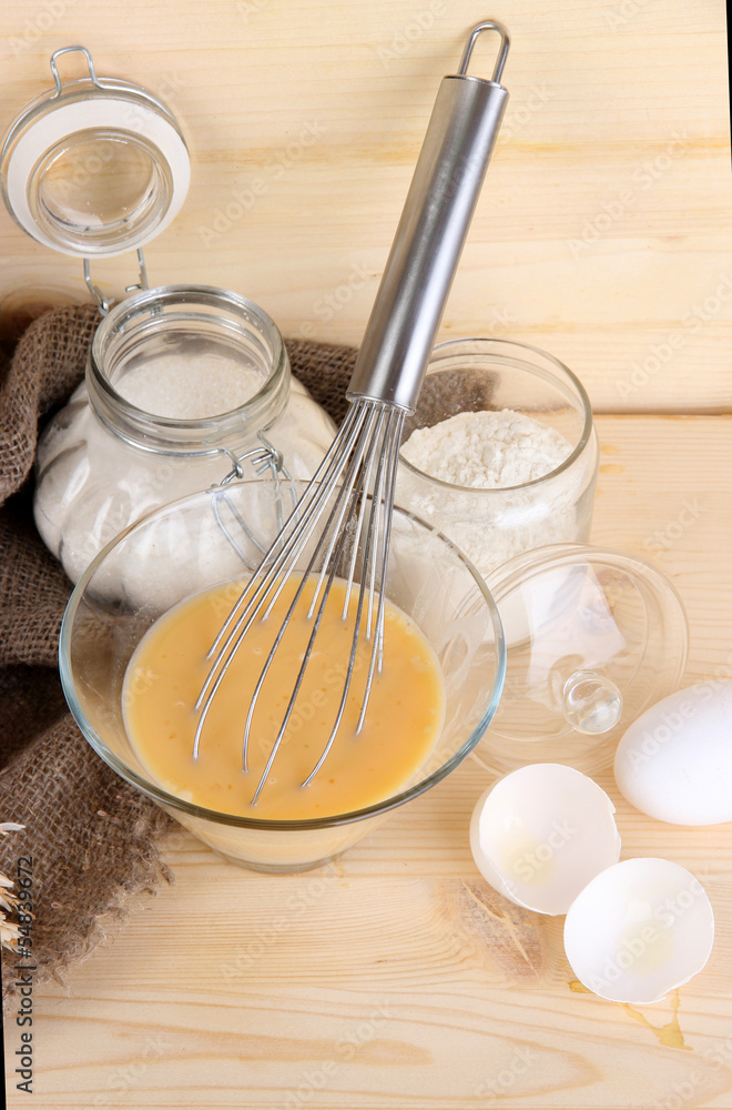 Ingredients for dough on wooden table on wooden background Ingredients for dough on wooden table on wooden background