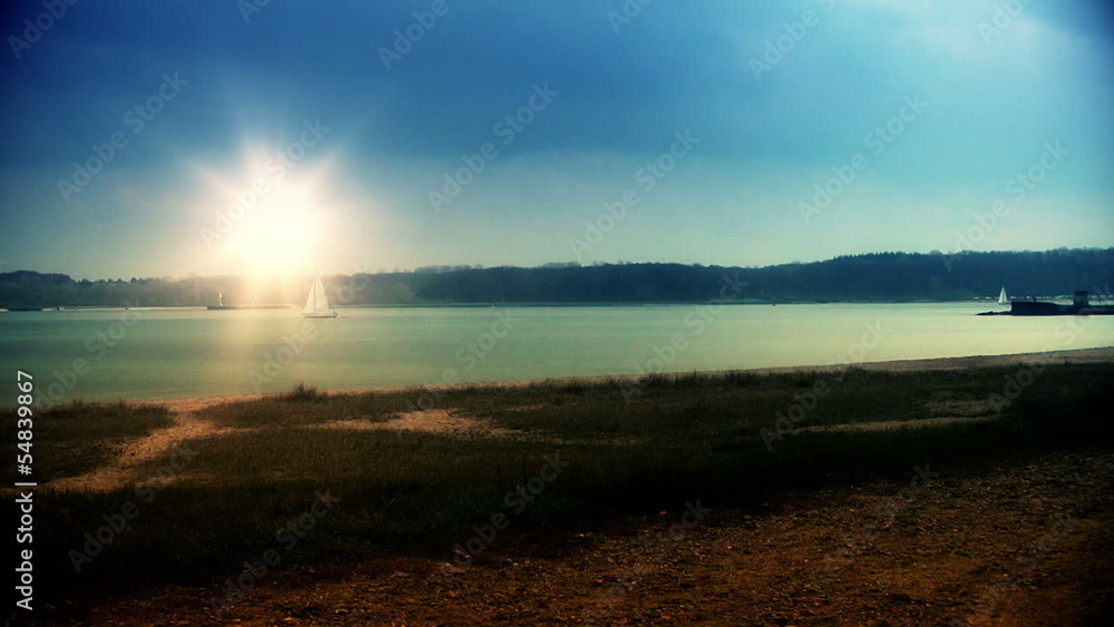 Lighthouse and sailing boats at sunset, zoom out