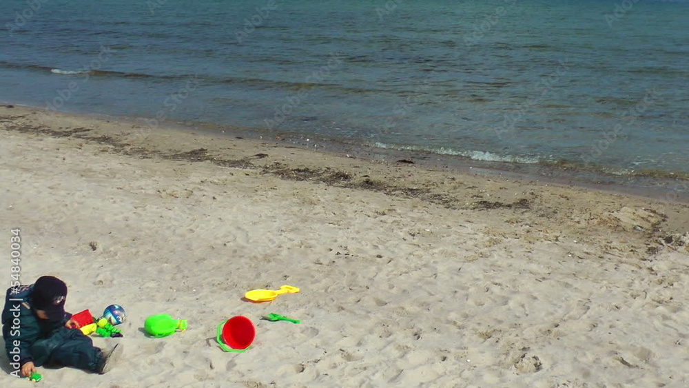 Little boy on the beach playing, panning Little boy on the beach playing, panning