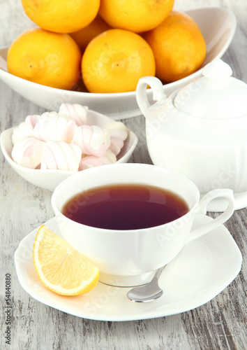 Cup of tea with lemon on table close-up