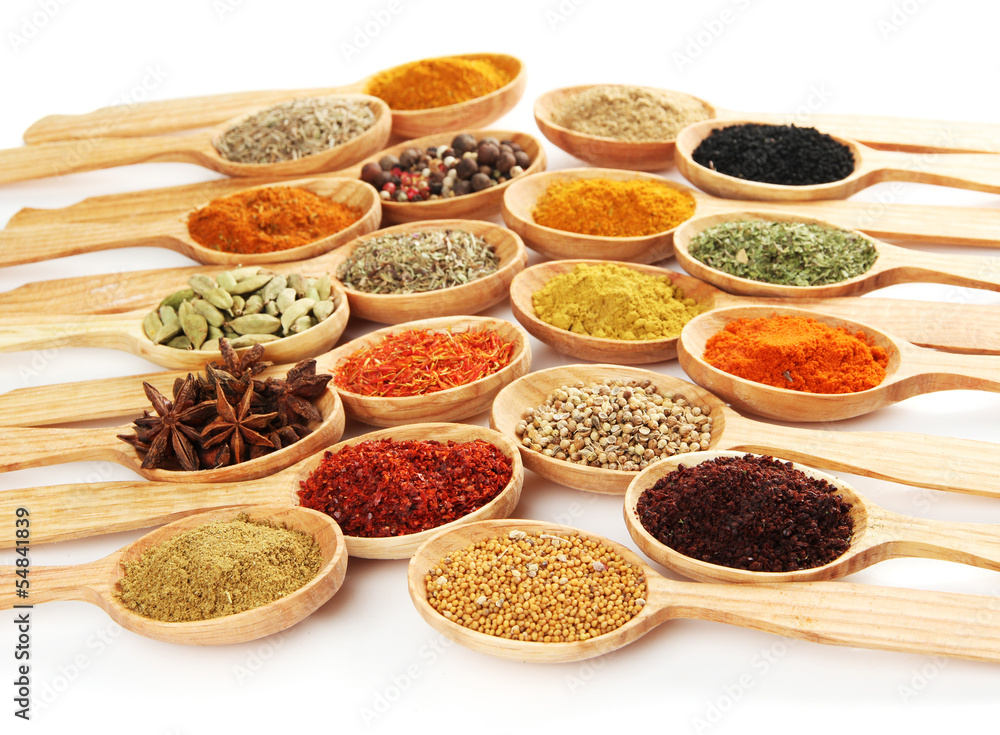Assortment of spices in wooden spoons, isolated on white Assortment of spices in wooden spoons, isolated on white