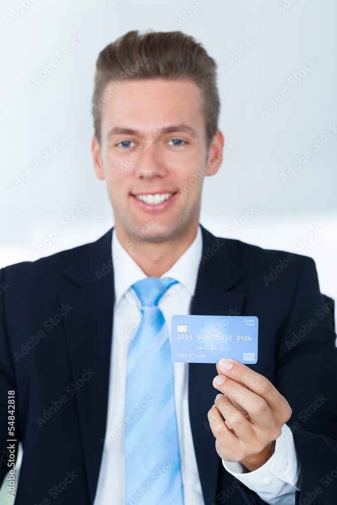 Portrait Of Young Happy Businessman Holding Credit Card Portrait Of Young Happy Businessman Holding Credit Card