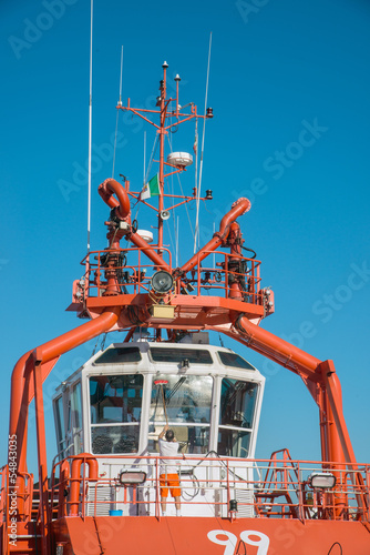 cleaning windows of the cockpit of the tug