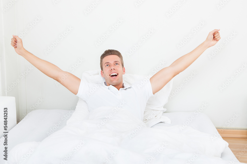 Man Waking Up In Morning And Stretching On Bed Man Waking Up In Morning And Stretching On Bed