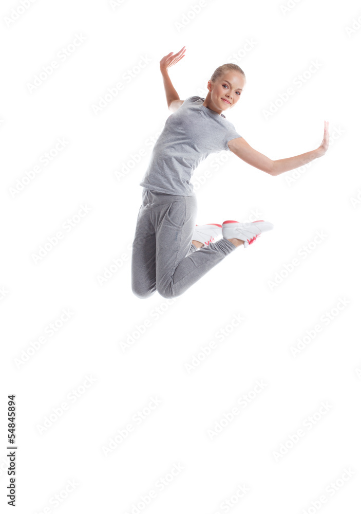 Image of smiling sporty girl jumping in studio
