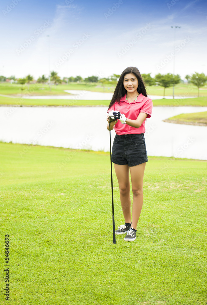 Girl golf player at green