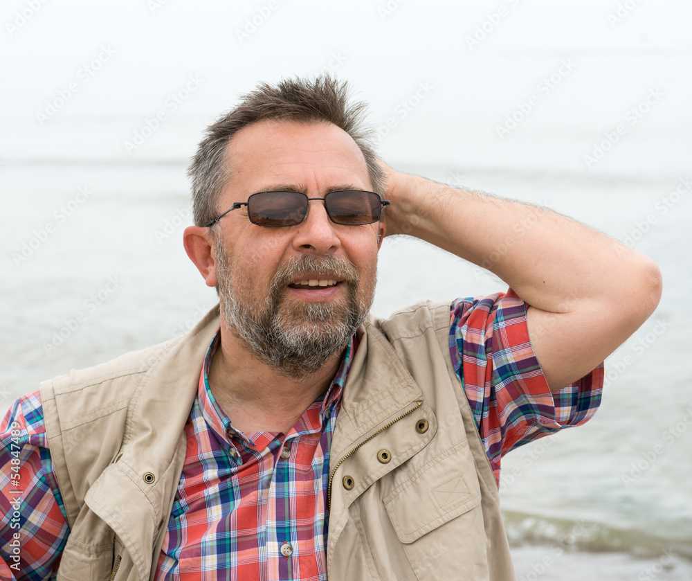 Peaceful carefree senior man on the sea background Peaceful carefree senior man on the sea background