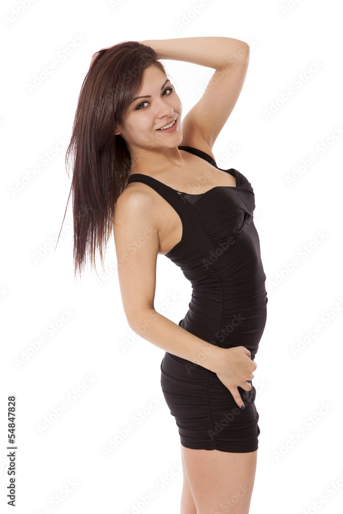 Young woman in a little black dress poses with her hand in her h Young woman in a little black dress poses with her hand in her h