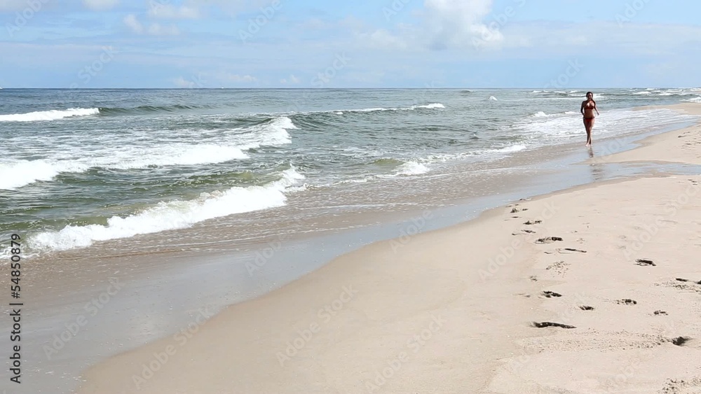 Beautiful woman running on the beach Beautiful woman running on the beach