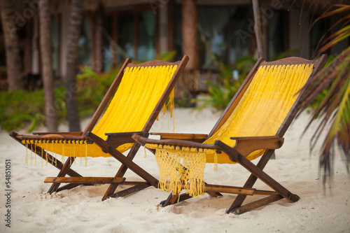 Two beach chairs on perfect tropical white sand beach in Tulum,