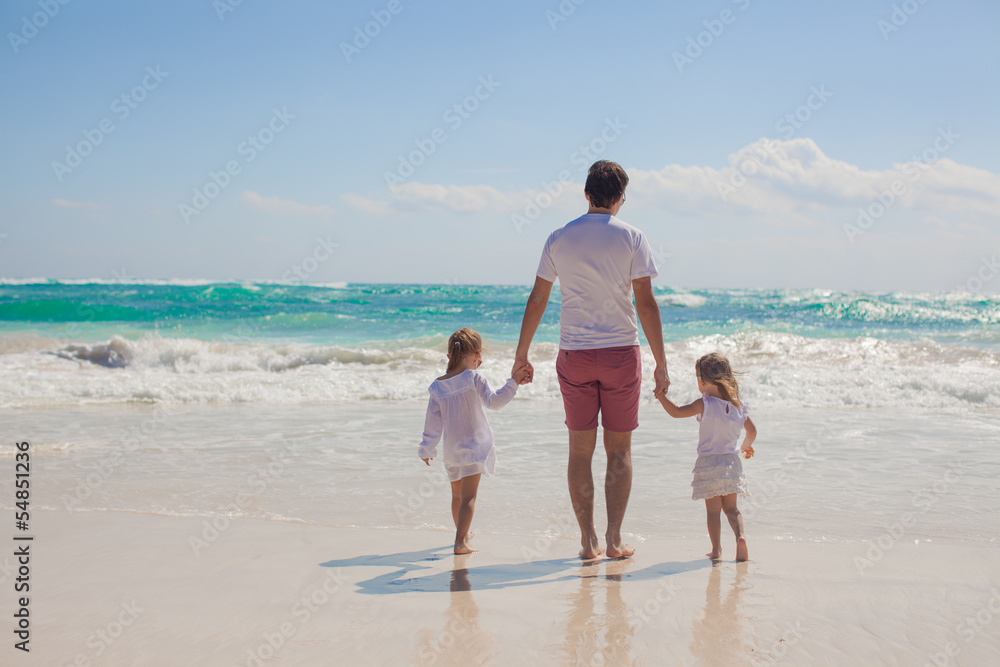 Back view of happy father and his adorable little daughters