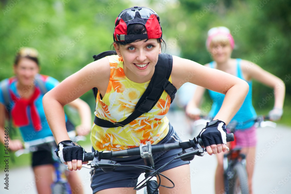 Three young girls on bicycle