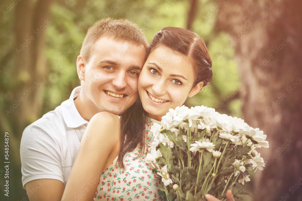 Love and affection between a young couple at the park Love and affection between a young couple at the park