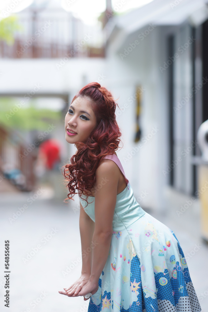 Beautiful young woman stand alone at the outdoor mall