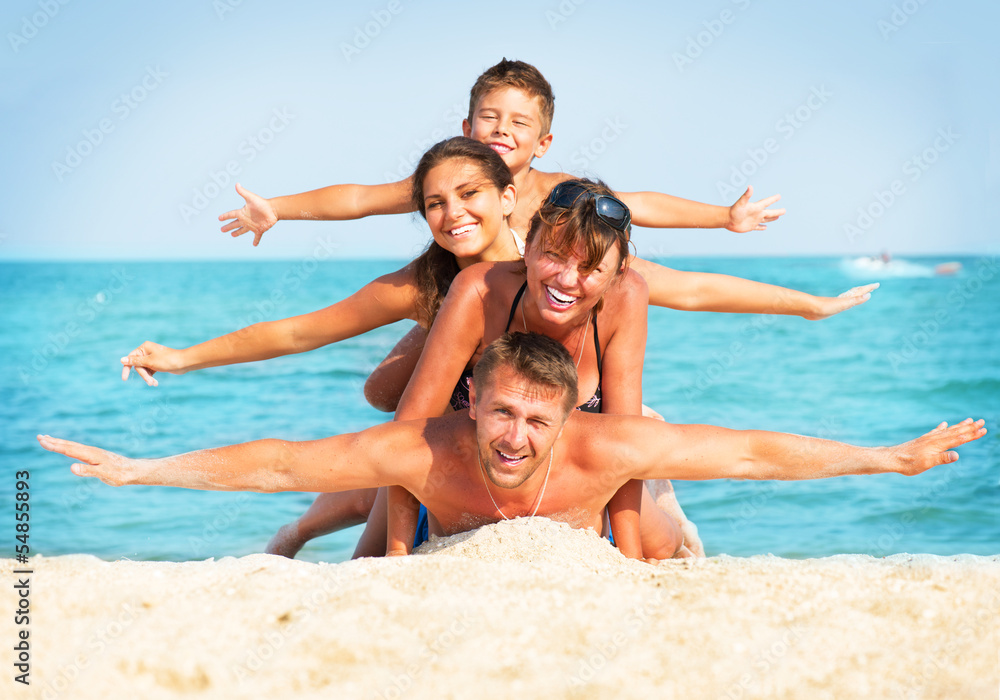 Happy Family Having Fun at the Beach. Summer Holidays Happy Family Having Fun at the Beach. Summer Holidays