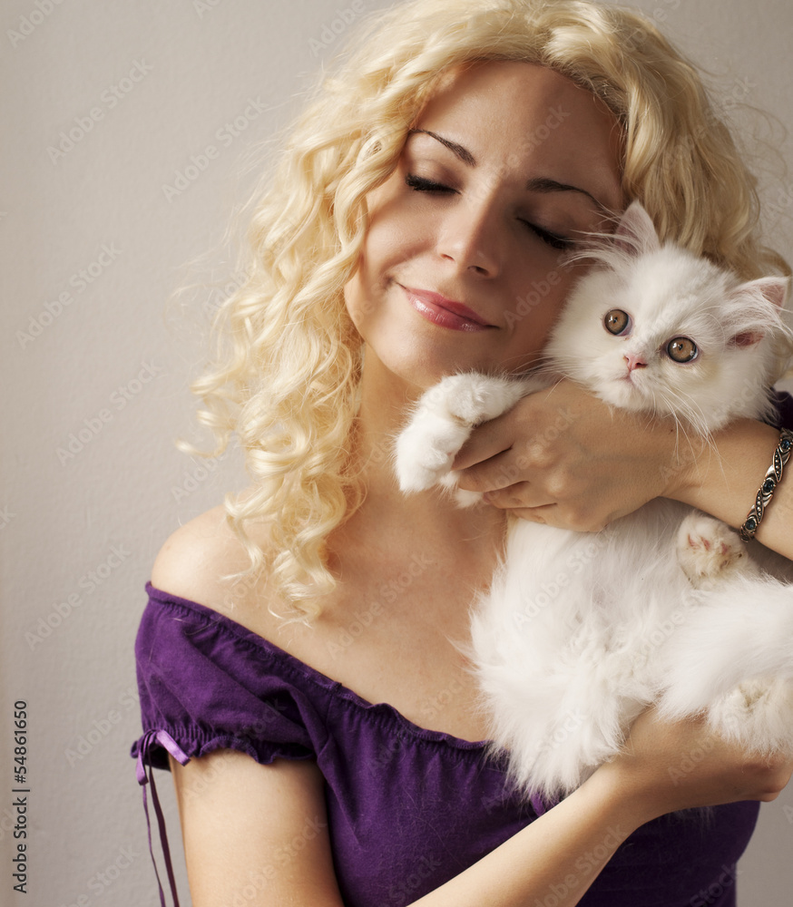 Beautiful young woman holding white Persian kitten Beautiful young woman holding white Persian kitten