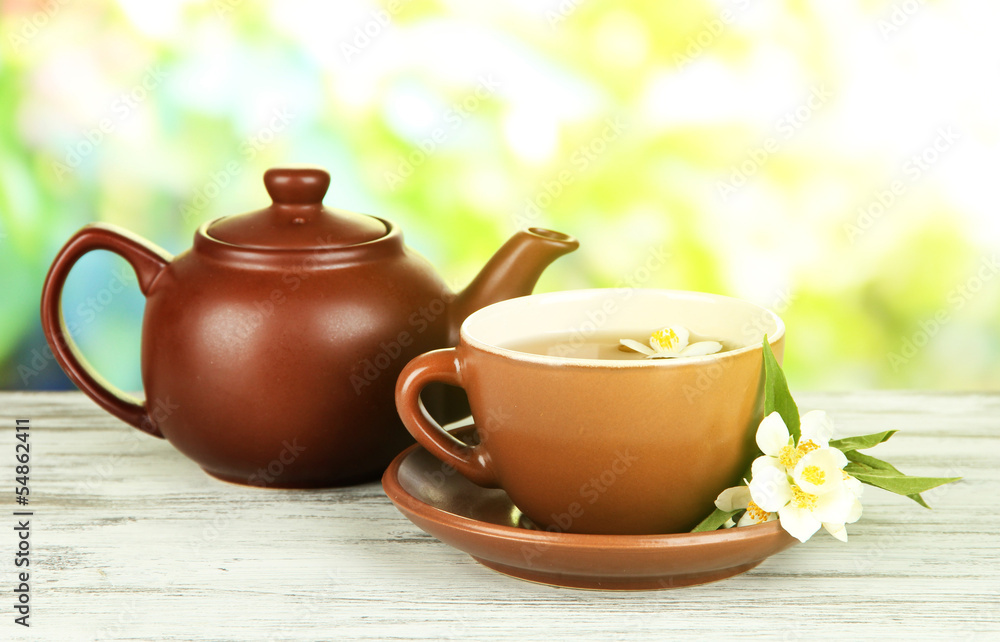 Cup of tea with jasmine, on bright background