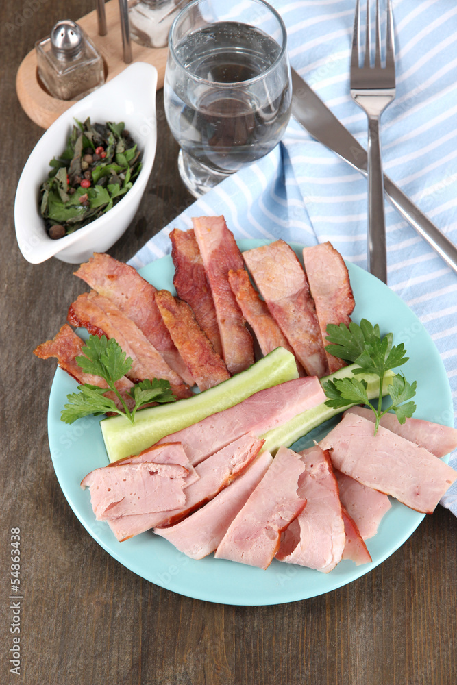 Bacon on plate on napkin on board on window table Bacon on plate on napkin on board on window table