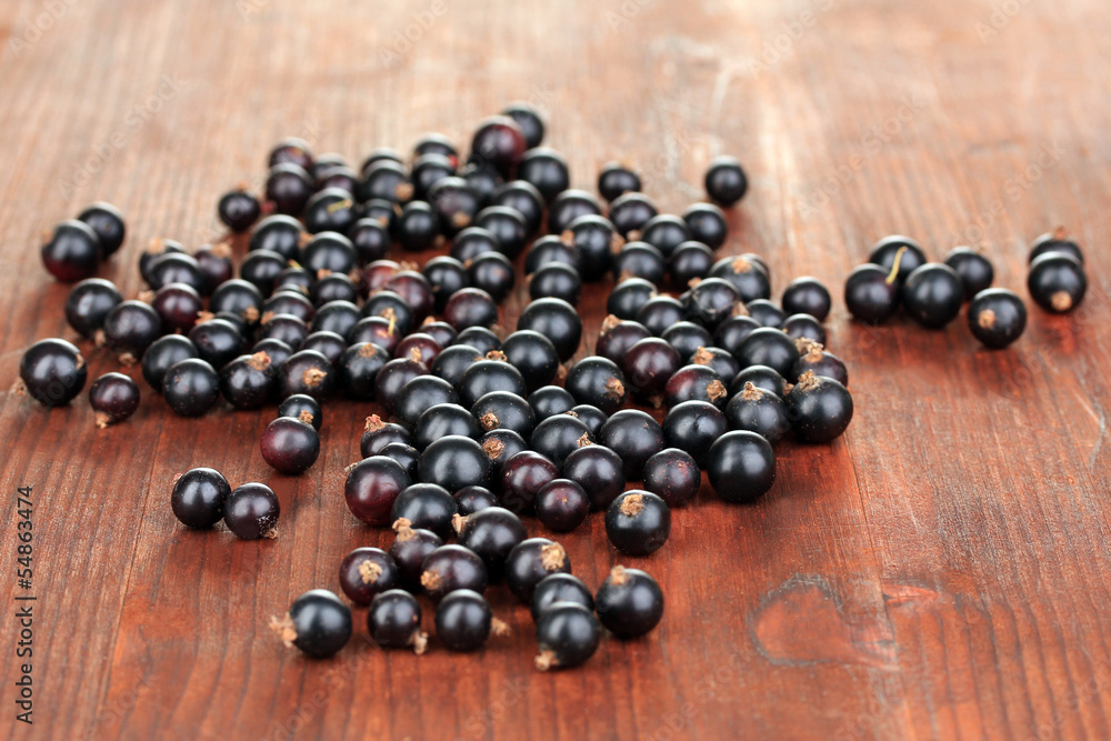 Fresh black currant on wooden background Fresh black currant on wooden background