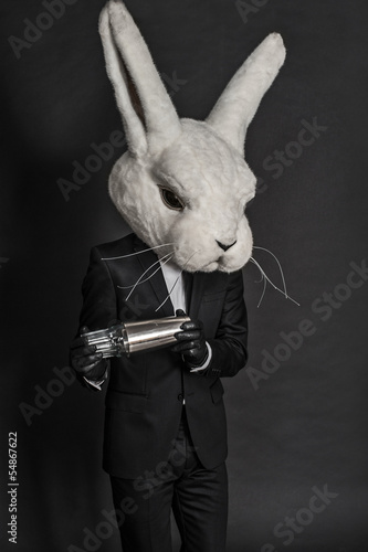 man in hare mask . black suit barman on gray background