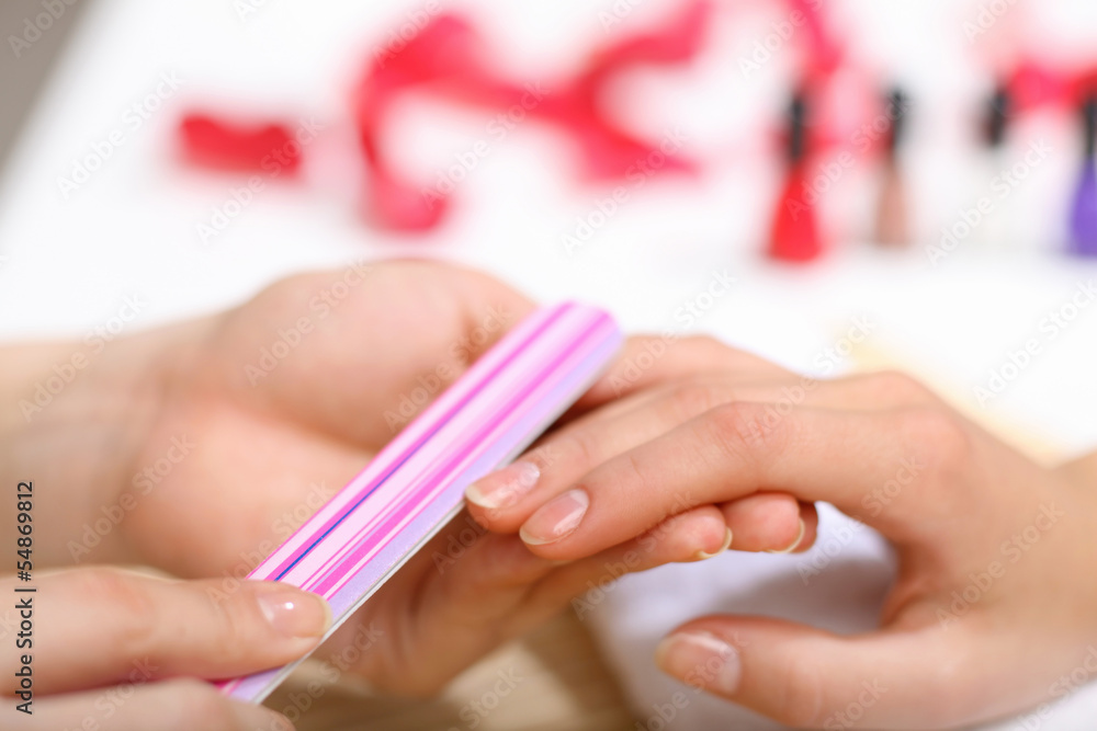 Woman is getting manicure Woman is getting manicure