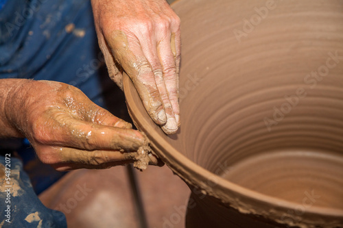 Potter works with clay in ceramics studio