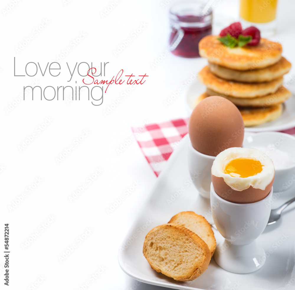 Fresh breakfast with eggs, pancakes, jam and juice Fresh breakfast with eggs, pancakes, jam and juice