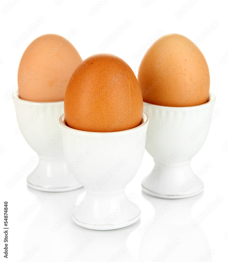 Whole boiled eggs in eggs cups isolated on white Whole boiled eggs in eggs cups isolated on white
