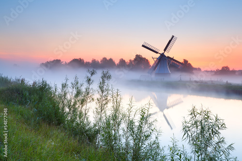 charming Dutch windmill by river