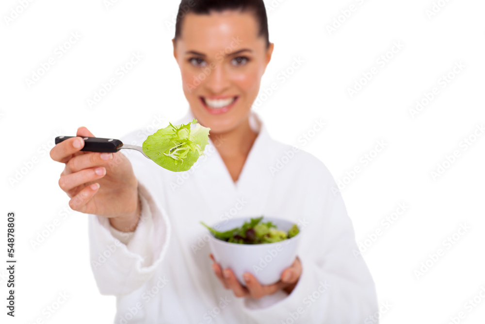 young woman giving fork with green salad young woman giving fork with green salad