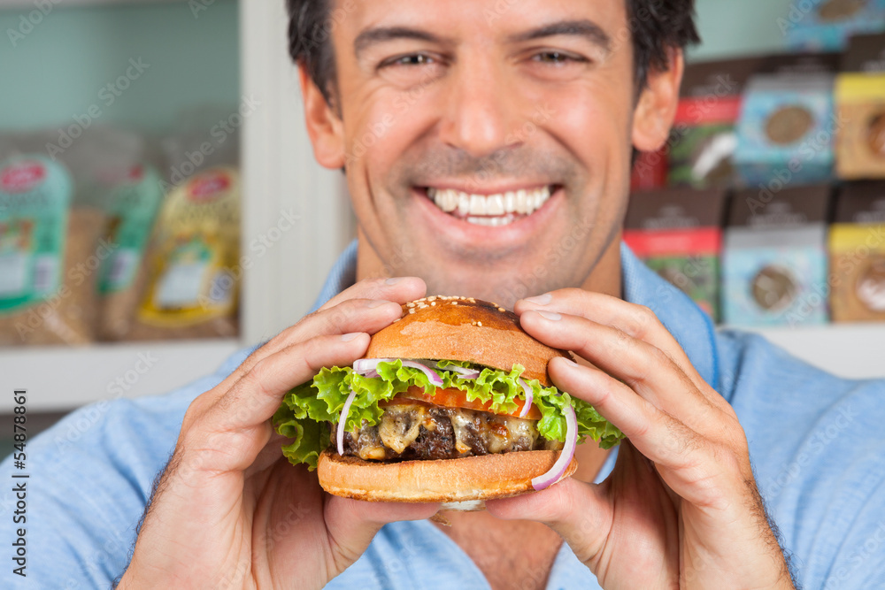 Happy Man Holding Bugger In Grocery Store Happy Man Holding Bugger In Grocery Store
