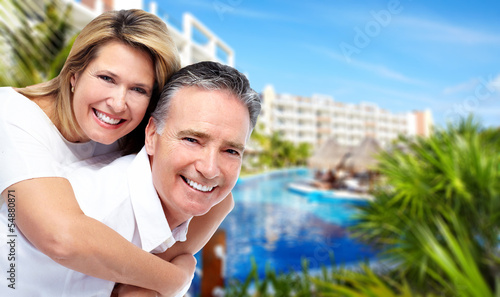 Happy senior couple at tropical resort.