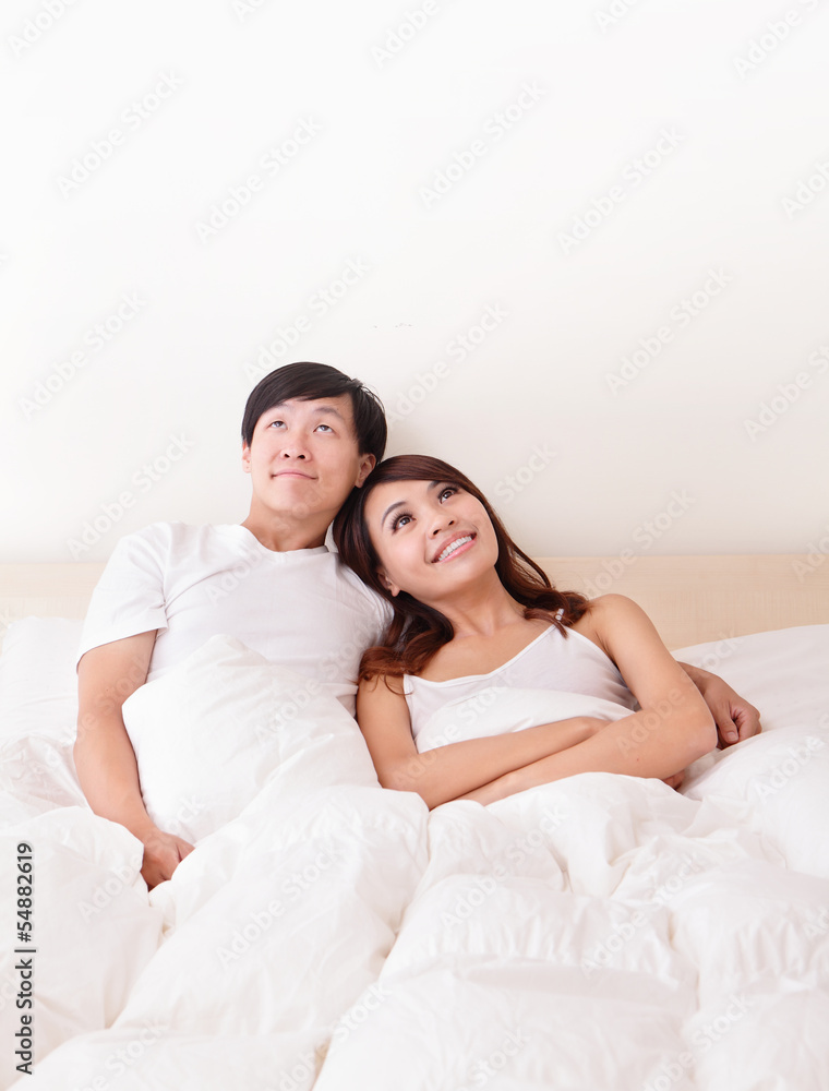 couple happy smile looking to empty copy space in bed couple happy smile looking to empty copy space in bed