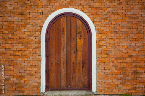 door on Red brick wall background © Nonwarit