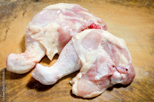 Legs of a chicken on cutting board
