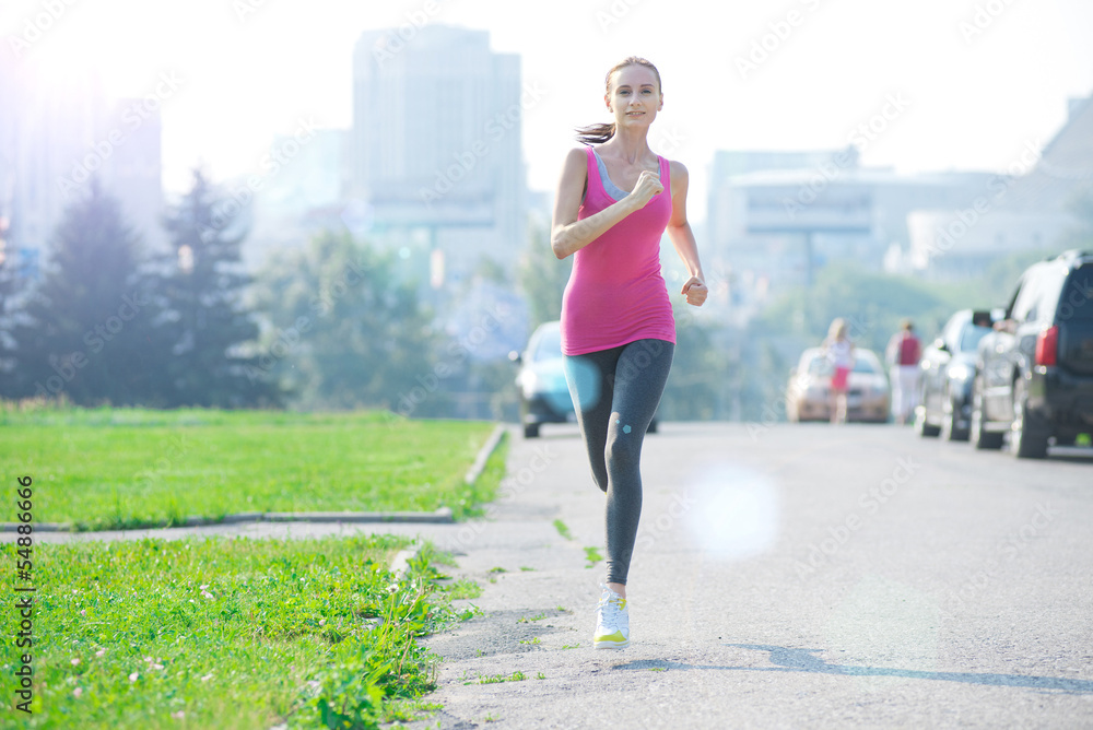 Jogging woman running in city park