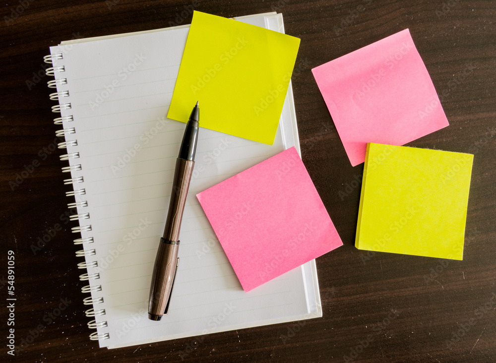notepad with pen and reminder notes on the table notepad with pen and reminder notes on the table
