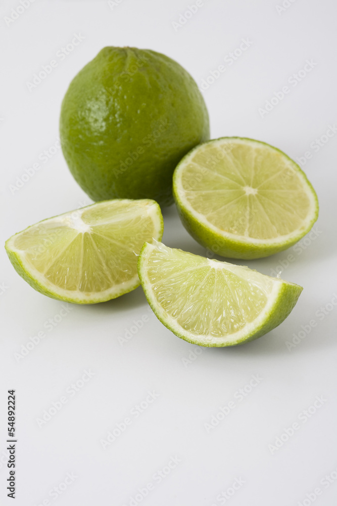 Whole and sliced limes