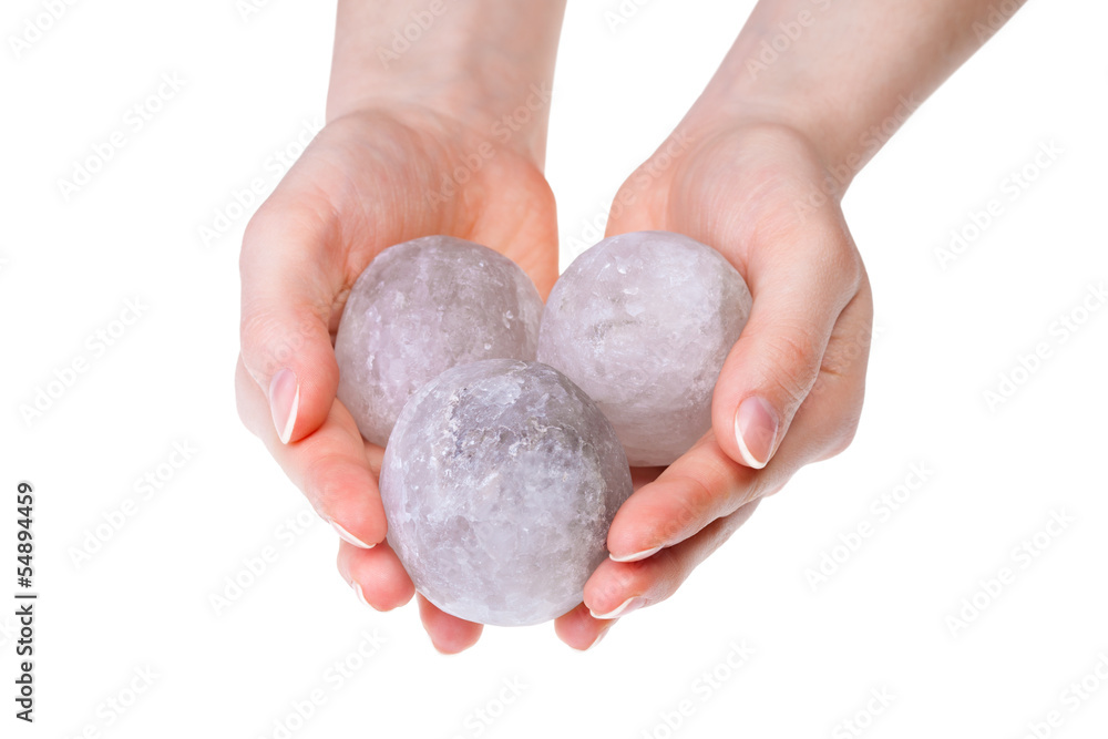 Woman's hands holding salt crystals for alternative medicine Woman's hands holding salt crystals for alternative medicine