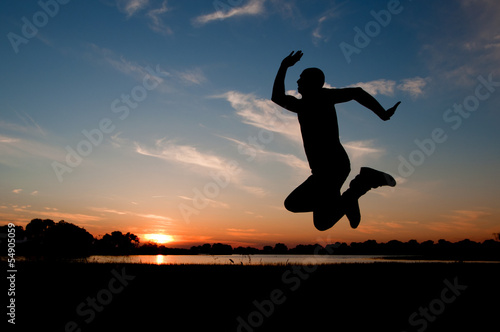 silhouette of a man jumping in the sunset
