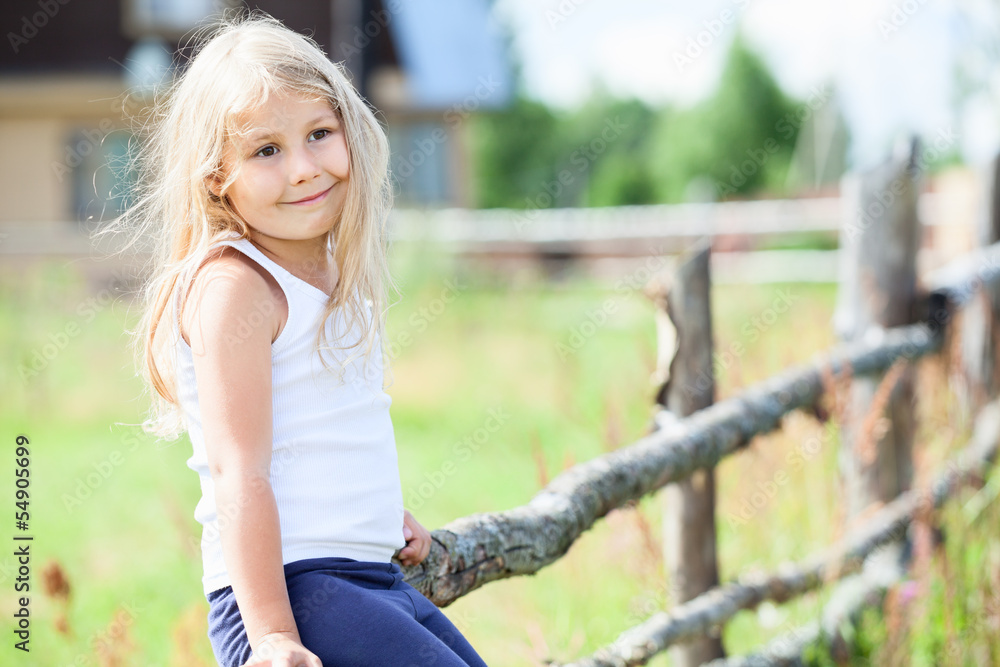 Pretty little girl in white singlet sitting on fence. Copyspace Pretty little girl in white singlet sitting on fence. Copyspace