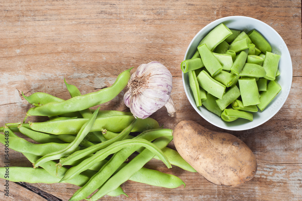 Green beans, potato and garlic, on a wooden table Green beans, potato and garlic, on a wooden table