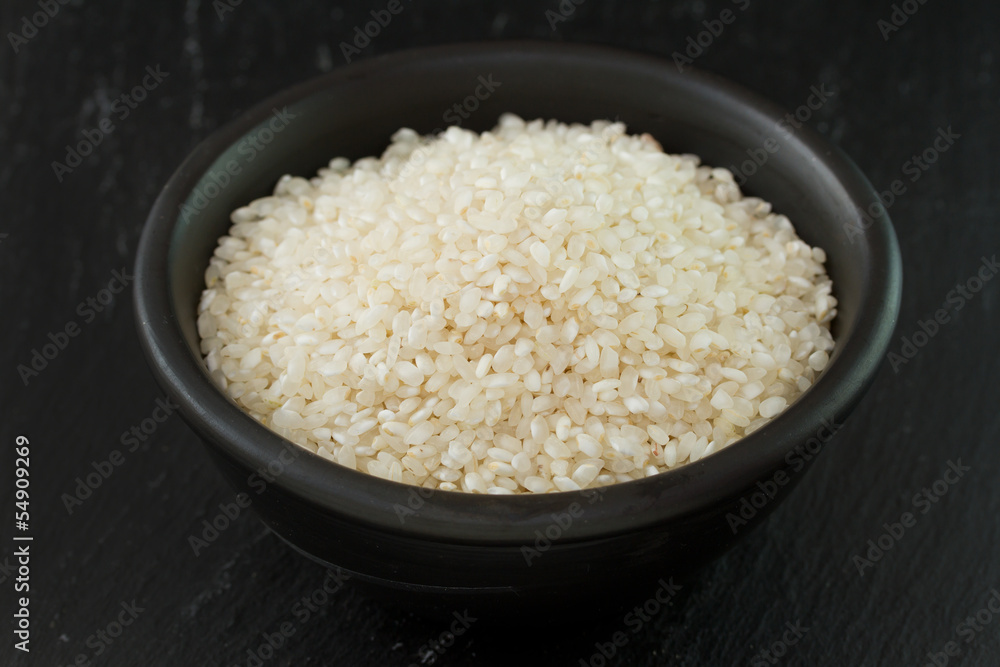 dry rice in black bowl dry rice in black bowl