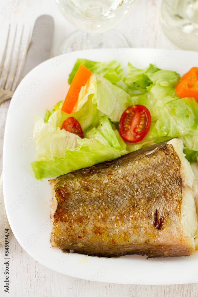 fish with fresh salad on the plate fish with fresh salad on the plate