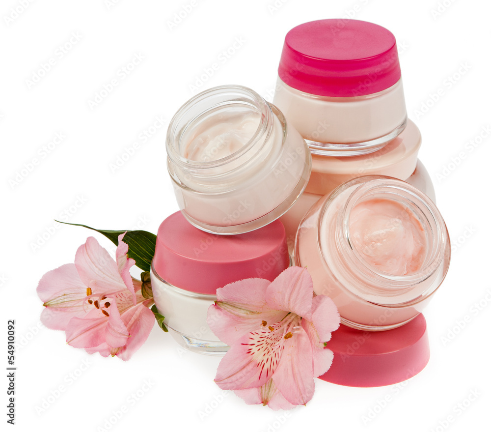 Cosmetic cream for make-up and fresh flowers isolated on white b Cosmetic cream for make-up and fresh flowers isolated on white b