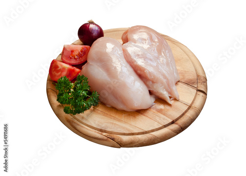 Isolated cutting board with raw chicken breast